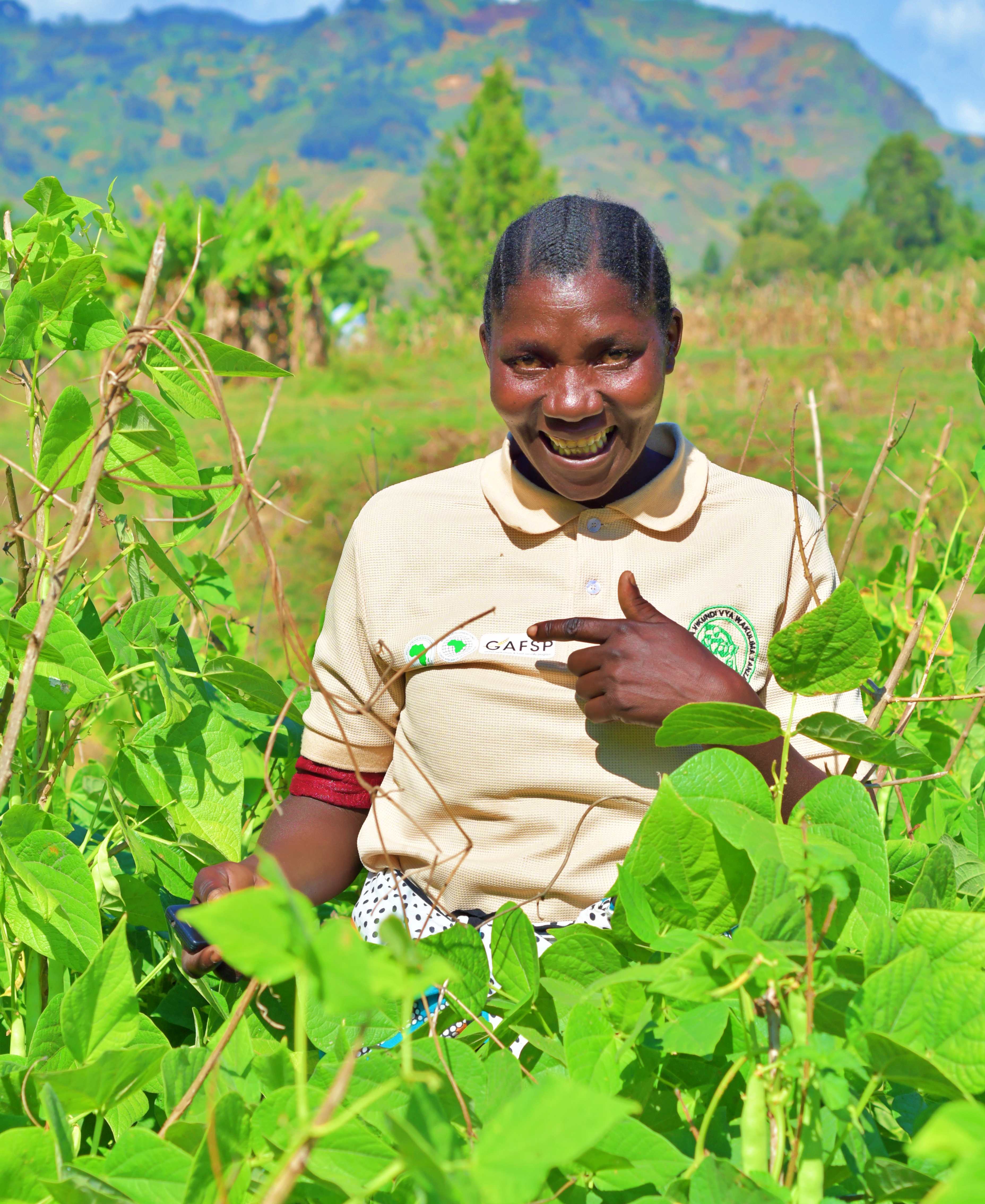 Anna Maria Mbiki of the GAFSP-funded Baridi Sokoni Project, standing at her bean farm. Photo: ESAFF
