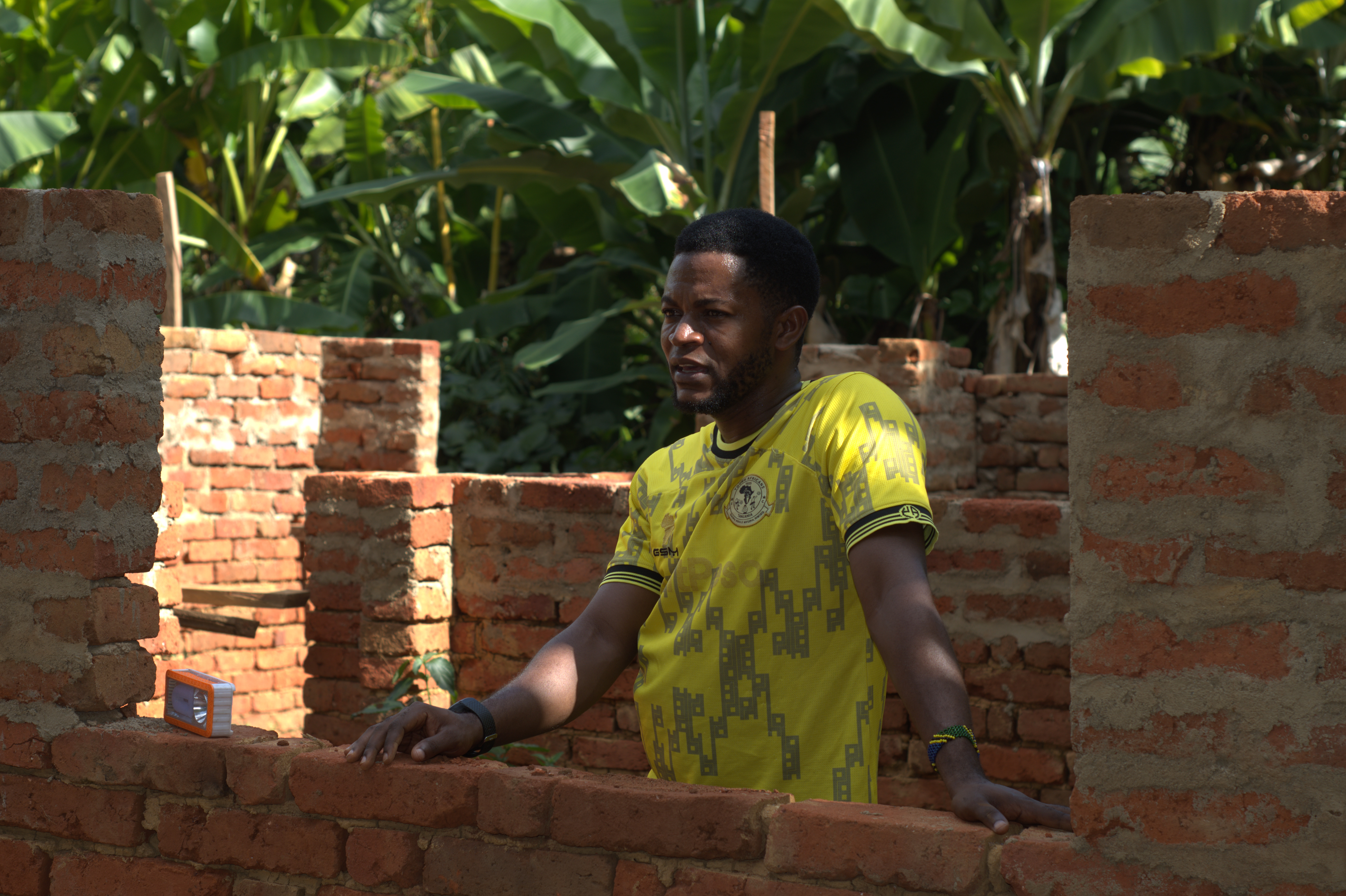 Zuberi Nasibu standing at the site of his house, a milestone achieved through income earned from selling spices under the Baridi Sokoni Project. Photo: ESAFF