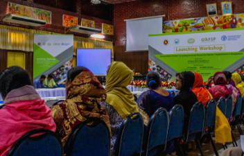 Women and men participating in a meeting in a conference room